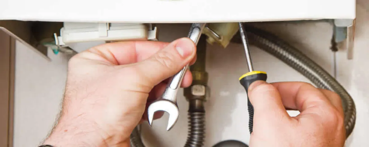 Boiler repair technician tightening pipe fittings and connections in Marietta, GA