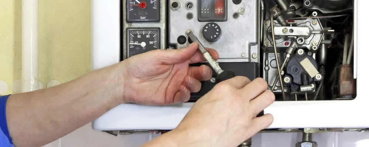 Heating repair technician adjusting boiler controls and components in Marietta, GA
