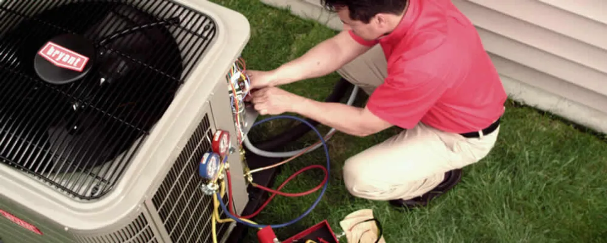 HVAC technician servicing an outdoor air conditioner unit in Marietta, GA