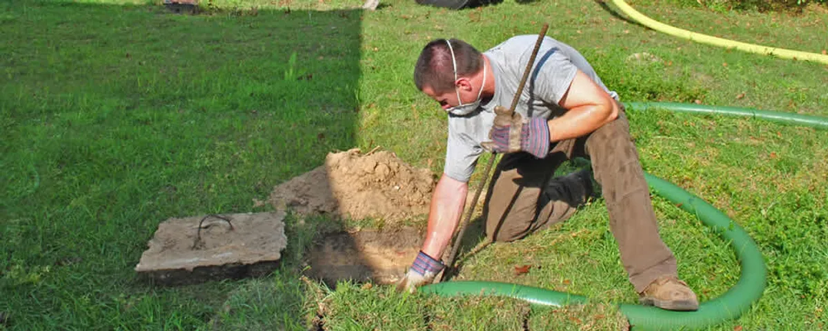 Septic pumping technician servicing a residential septic tank in Marietta, GA